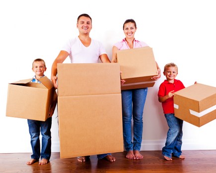 Removal team helping with household moving boxes in Hainault