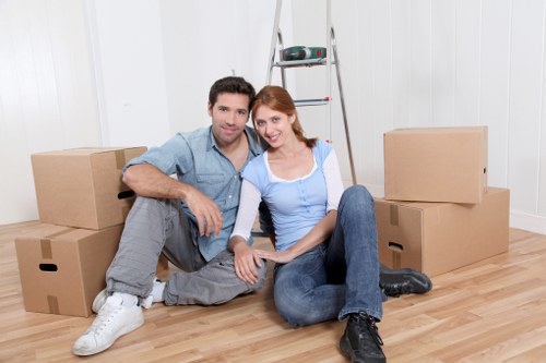 Professional house movers helping a family move in Hainault