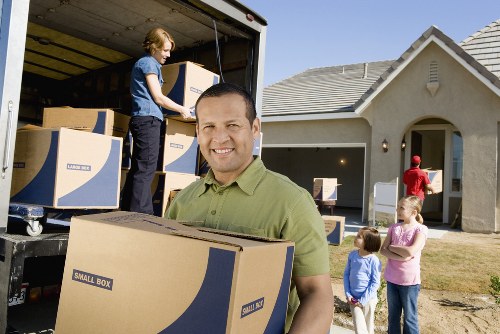 Unpacking boxes and arranging essentials in a new Hainault property