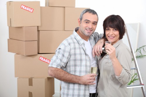Loading furniture and boxes into a removal van in Hainault